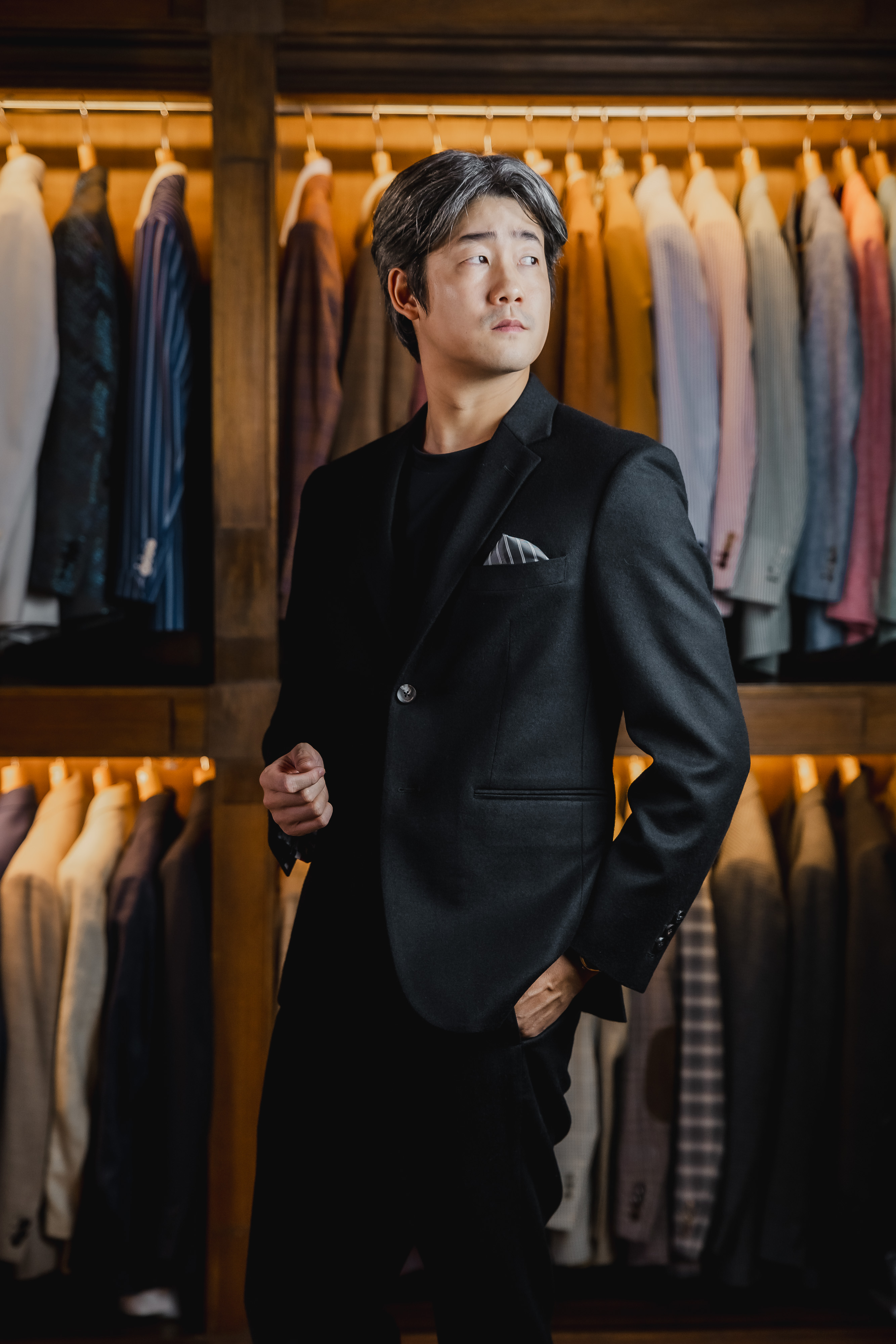 Black suit, confident standing pose