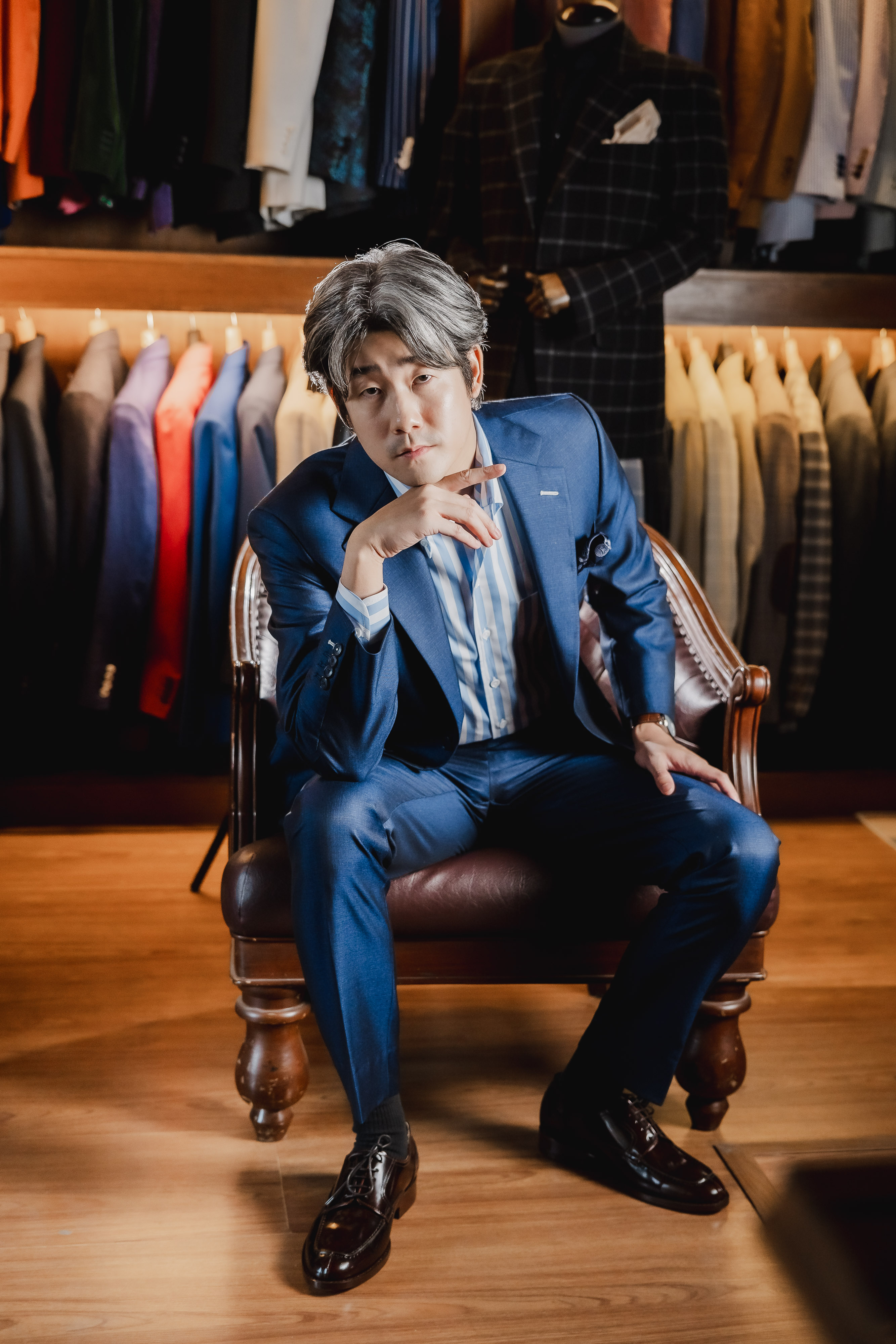 Blue suit with tie seated