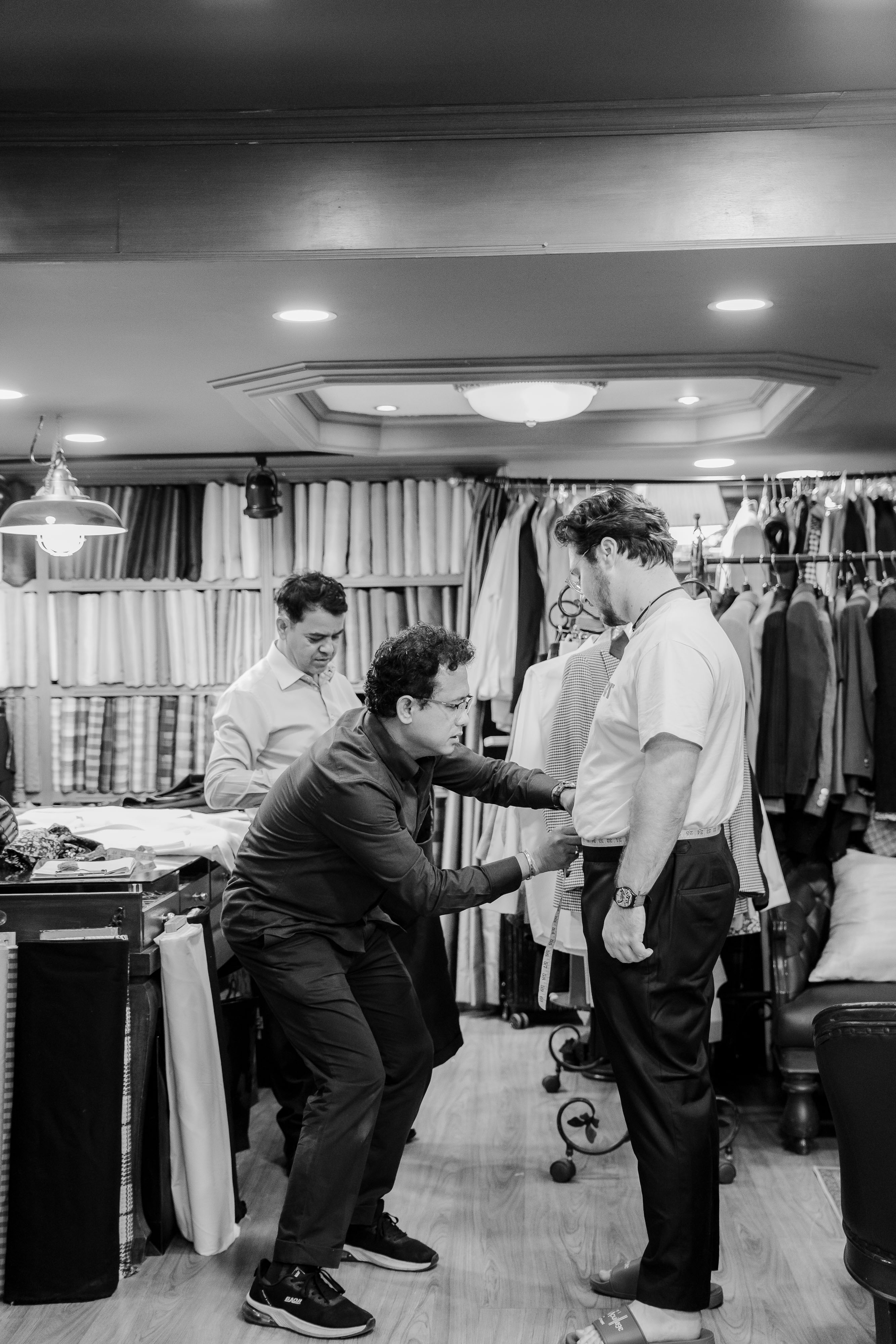 Tailor fitting a customer